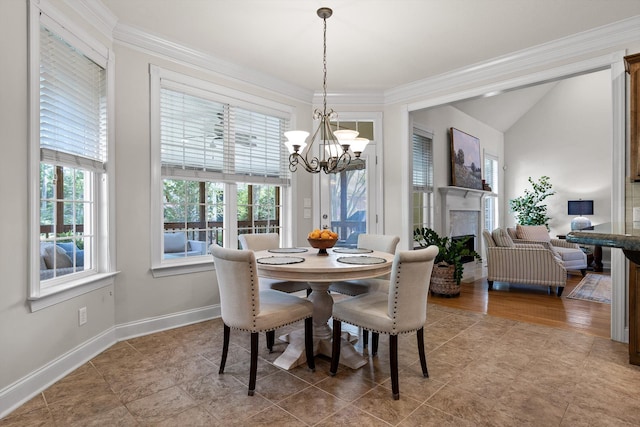 dining room featuring baseboards, crown molding, lofted ceiling, and a notable chandelier