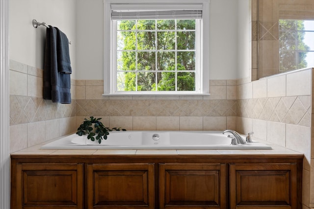 bathroom featuring a healthy amount of sunlight and a bath