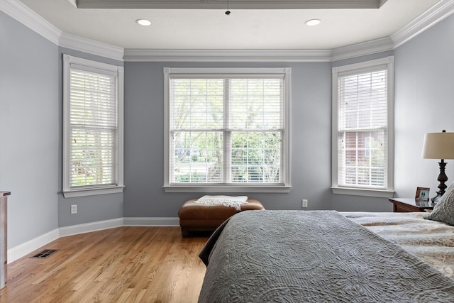 bedroom with light wood-type flooring, visible vents, and multiple windows