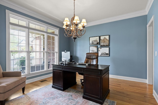 office space with an inviting chandelier, baseboards, crown molding, and light wood-type flooring
