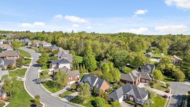 drone / aerial view featuring a forest view and a residential view