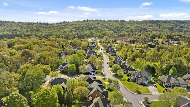 drone / aerial view with a view of trees and a residential view
