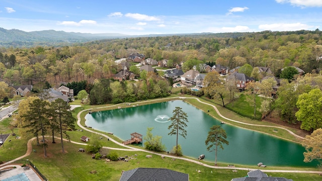 aerial view featuring a water view, a view of trees, and a residential view