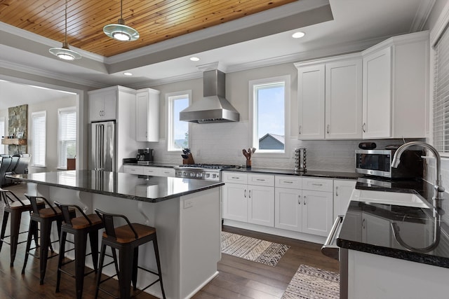 7407 Pond Vw, Harrison, TN 37341 - kitchen featuring ornamental molding, high end fridge, wall chimney exhaust hood, a tray ceiling, and range