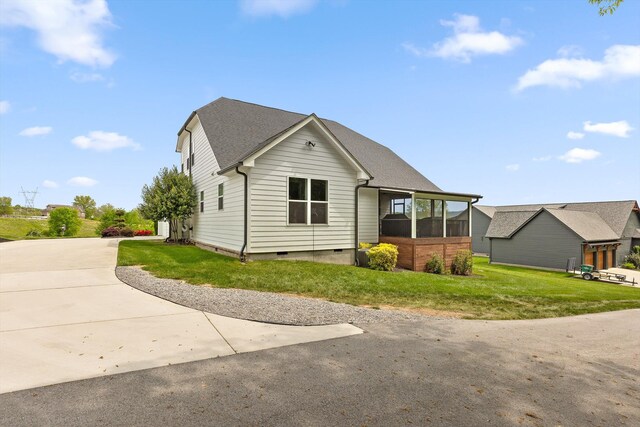 7407 Pond Vw, Harrison, TN 37341 - exterior space with a sunroom, a front lawn, roof with shingles, and crawl space