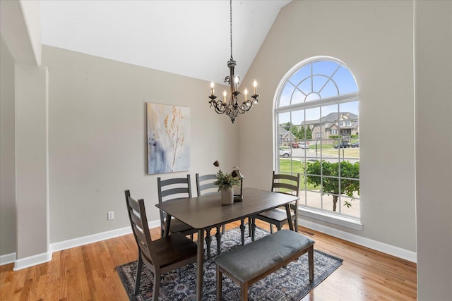 3874 Sweet Bay Ln, Apison, TN 37302 - dining room featuring light wood-style floors, a wealth of natural light, a notable chandelier, and high vaulted ceiling