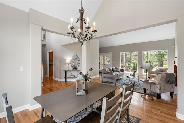 3874 Sweet Bay Ln, Apison, TN 37302 - dining space with a chandelier, high vaulted ceiling, light wood finished floors, and baseboards