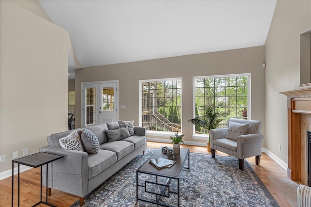 3874 Sweet Bay Ln, Apison, TN 37302 - living area with a fireplace with flush hearth, lofted ceiling, wood finished floors, and baseboards