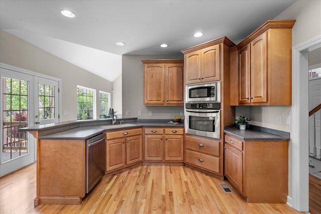3874 Sweet Bay Ln, Apison, TN 37302 - kitchen featuring light wood finished floors, stainless steel appliances, a sink, dark countertops, and visible vents