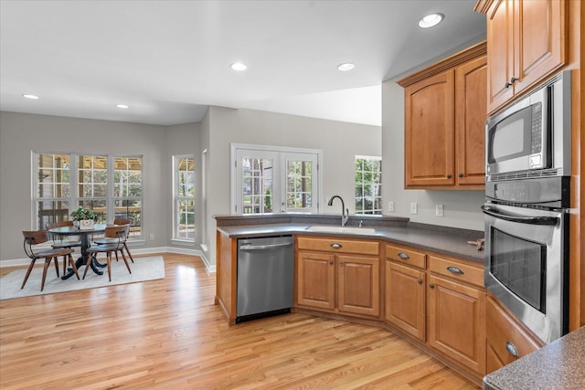 3874 Sweet Bay Ln, Apison, TN 37302 - kitchen featuring a sink, dark countertops, recessed lighting, light wood-style floors, and appliances with stainless steel finishes