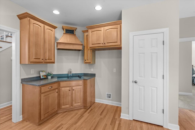 3874 Sweet Bay Ln, Apison, TN 37302 - kitchen with custom exhaust hood, dark countertops, light wood-type flooring, black electric cooktop, and baseboards