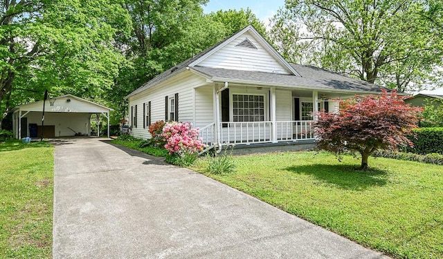 bungalow-style home featuring a front lawn, driveway, a carport, covered porch, and roof with shingles