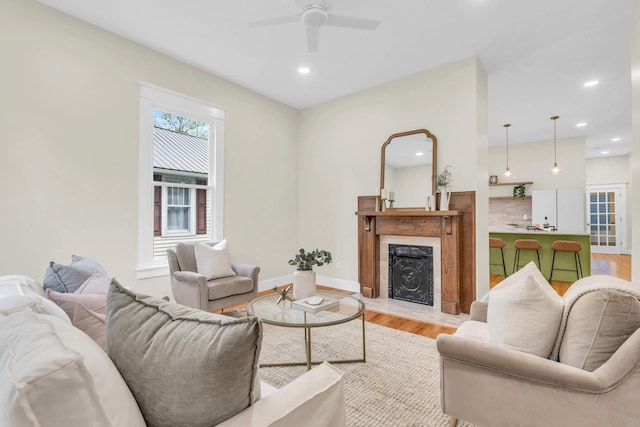 5107 Beulah Ave, Chattanooga, TN 37409 - living area with a fireplace with flush hearth, baseboards, recessed lighting, light wood-style floors, and ceiling fan