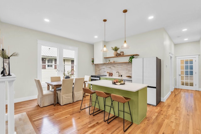 5107 Beulah Ave, Chattanooga, TN 37409 - kitchen featuring freestanding refrigerator, a kitchen bar, a kitchen island, and light wood finished floors