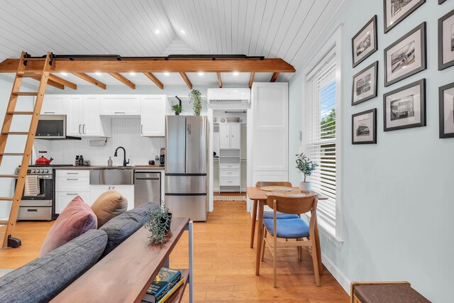 5107 Beulah Ave, Chattanooga, TN 37409 - kitchen with a sink, light wood-style floors, white cabinetry, backsplash, and appliances with stainless steel finishes