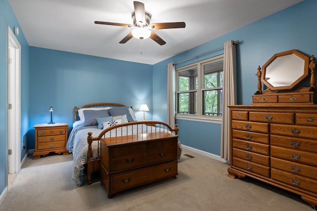 carpeted bedroom with baseboards and a ceiling fan