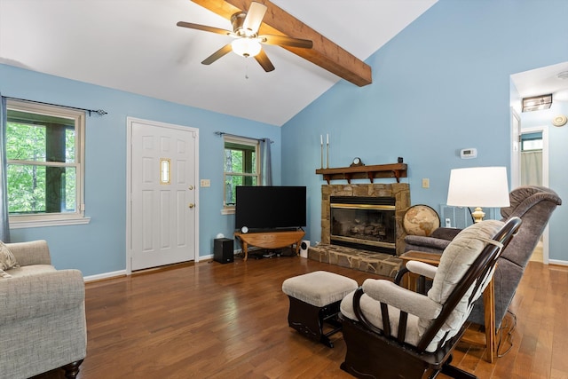 living area featuring ceiling fan, a fireplace, wood finished floors, baseboards, and vaulted ceiling with beams
