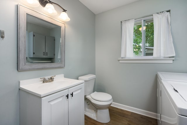 5407 Marion Ave, Chattanooga, TN 37412 - bathroom featuring separate washer and dryer, vanity, wood finished floors, toilet, and baseboards