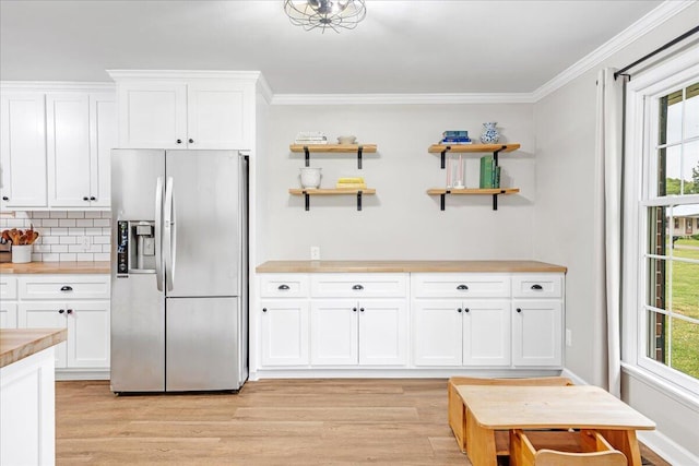kitchen featuring stainless steel fridge, plenty of natural light, and light wood-type flooring