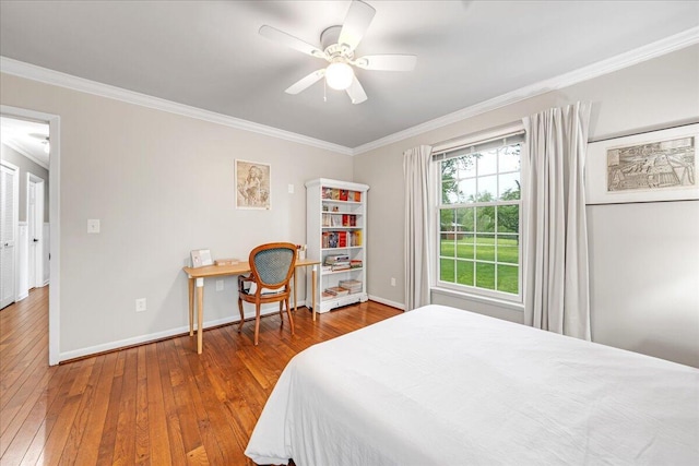 bedroom with wood-type flooring, a ceiling fan, crown molding, and baseboards