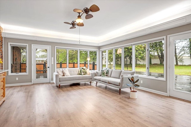 sunroom / solarium with baseboards and wood finished floors
