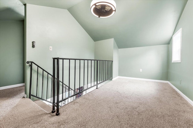 bonus room with baseboards, carpet, and lofted ceiling
