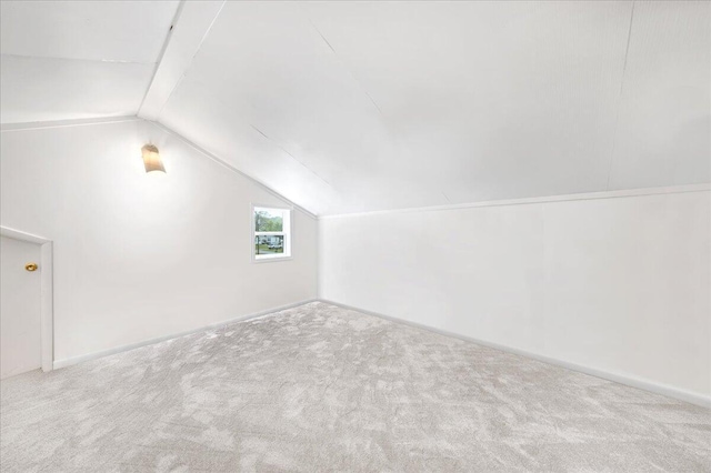 bonus room featuring carpet floors, baseboards, and lofted ceiling