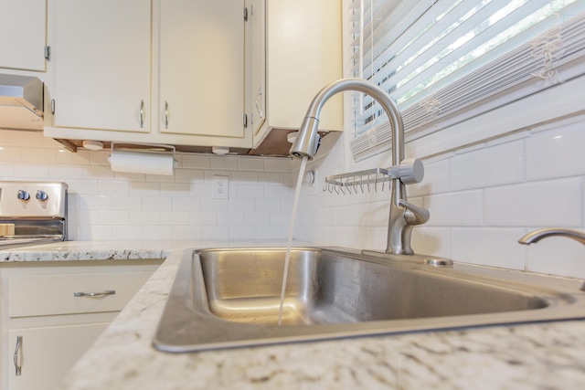 2031 Millard Rd, Soddy Daisy, TN 37379 - room details featuring tasteful backsplash, white cabinets, range hood, and a sink
