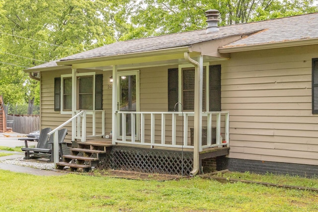 2031 Millard Rd, Soddy Daisy, TN 37379 - property entrance with a chimney, a shingled roof, covered porch, and fence