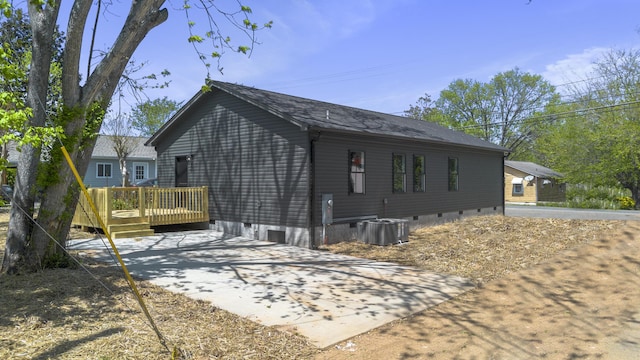 view of home's exterior featuring crawl space and a deck
