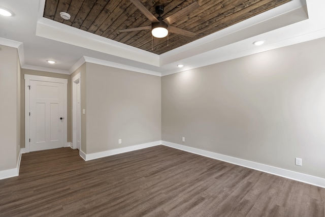 unfurnished room with a raised ceiling, a ceiling fan, and dark wood-style floors