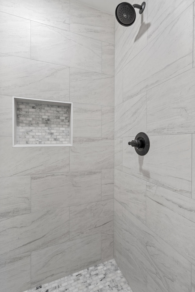 bathroom with a tile shower