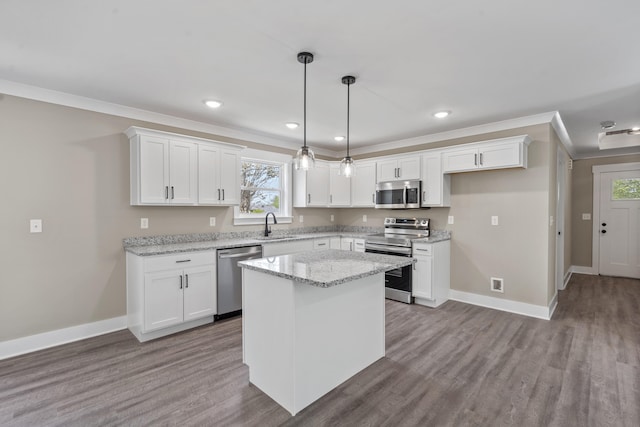 kitchen with a wealth of natural light, appliances with stainless steel finishes, a sink, and baseboards