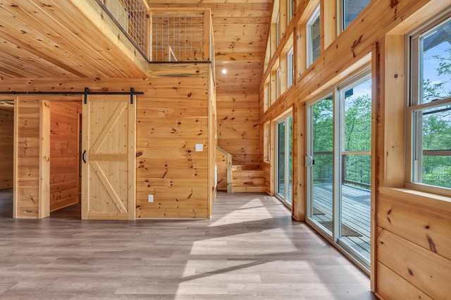 144 Hambright Rd, Reliance, TN 37369 - interior space featuring wooden walls, a barn door, and wood finished floors