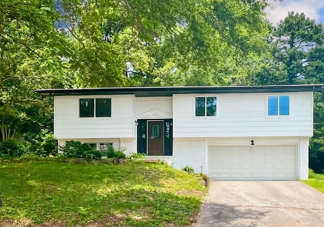 1157 Boy Scout Rd, Hixson, TN 37343 - raised ranch with an attached garage, concrete driveway, brick siding, and a front lawn