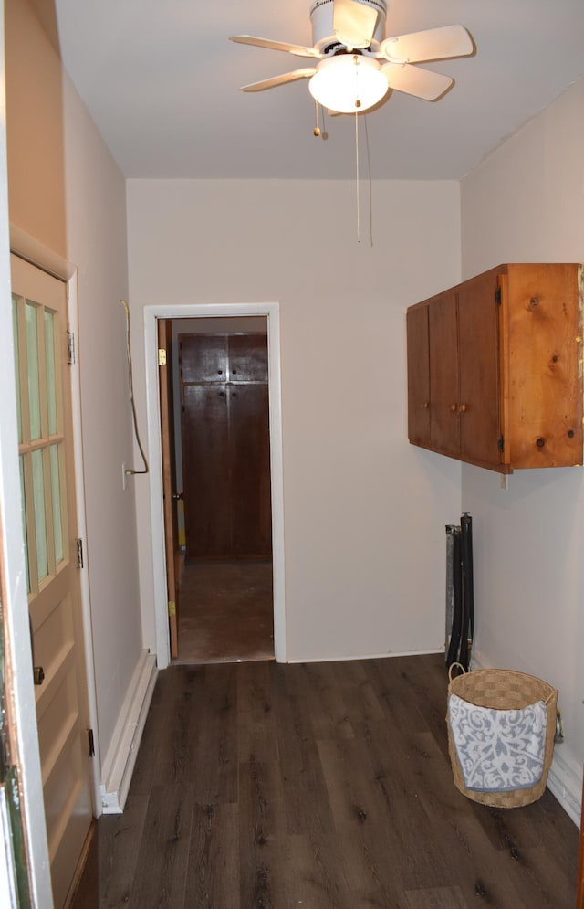 washroom featuring baseboard heating, a ceiling fan, and dark wood-type flooring