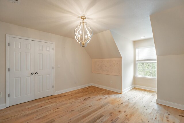330 Battlefield Cir, Ringgold, GA 30736 - additional living space featuring light wood-type flooring, baseboards, a chandelier, and vaulted ceiling
