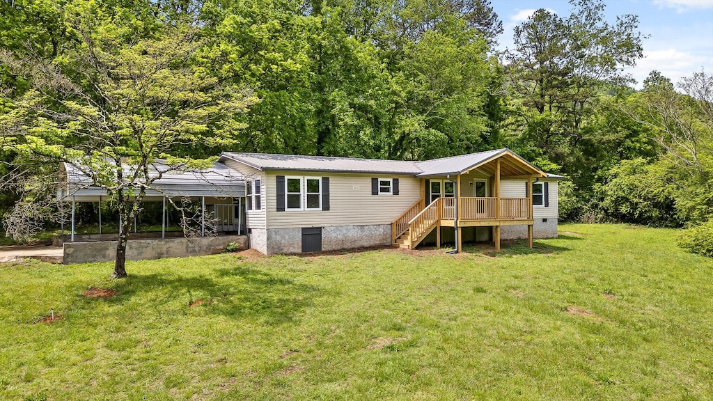 back of property featuring a deck, stairway, metal roof, crawl space, and a lawn