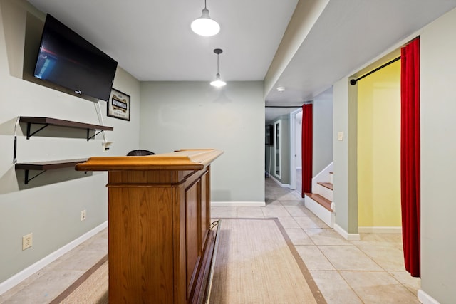 bar with baseboards, stairway, light tile patterned floors, and a bar