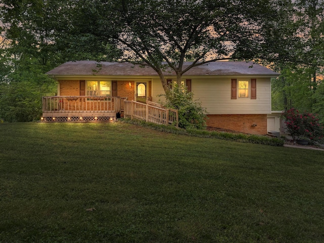 view of front of home with a yard and brick siding