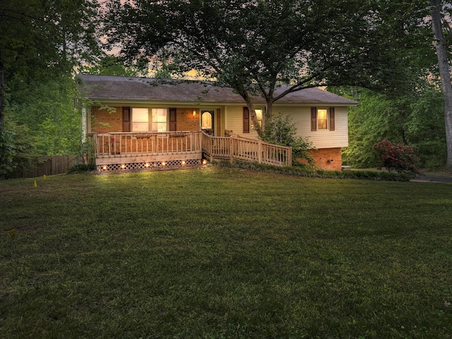 single story home featuring fence, a yard, and a porch