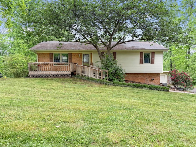 ranch-style home featuring a front lawn, a deck, and brick siding