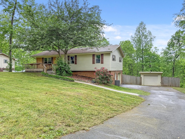 ranch-style home with a garage, an outbuilding, driveway, brick siding, and fence