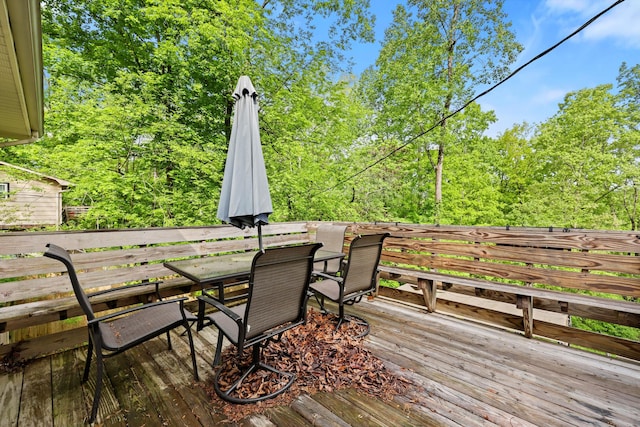 wooden terrace featuring outdoor dining area