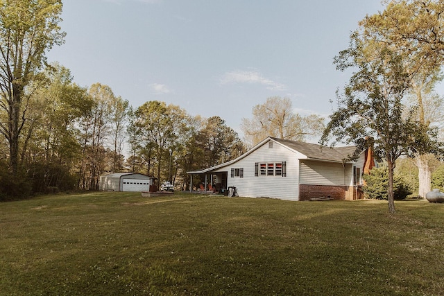 view of property exterior featuring a garage, an outdoor structure, a chimney, and a lawn