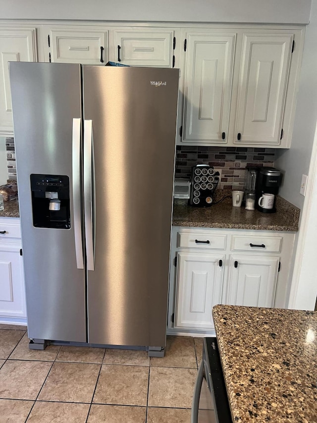 2288 Edgmon Forest Ln, Chattanooga, TN 37421 - kitchen with stainless steel fridge with ice dispenser, light tile patterned flooring, white cabinets, and dark stone countertops
