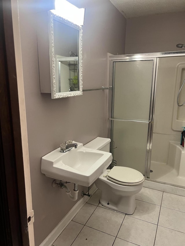 2288 Edgmon Forest Ln, Chattanooga, TN 37421 - bathroom with tile patterned floors, a stall shower, and a textured ceiling