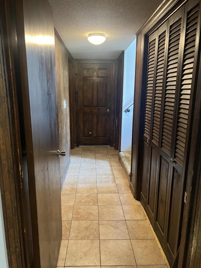 2288 Edgmon Forest Ln, Chattanooga, TN 37421 - hallway with a textured ceiling, light tile patterned floors, and wood walls