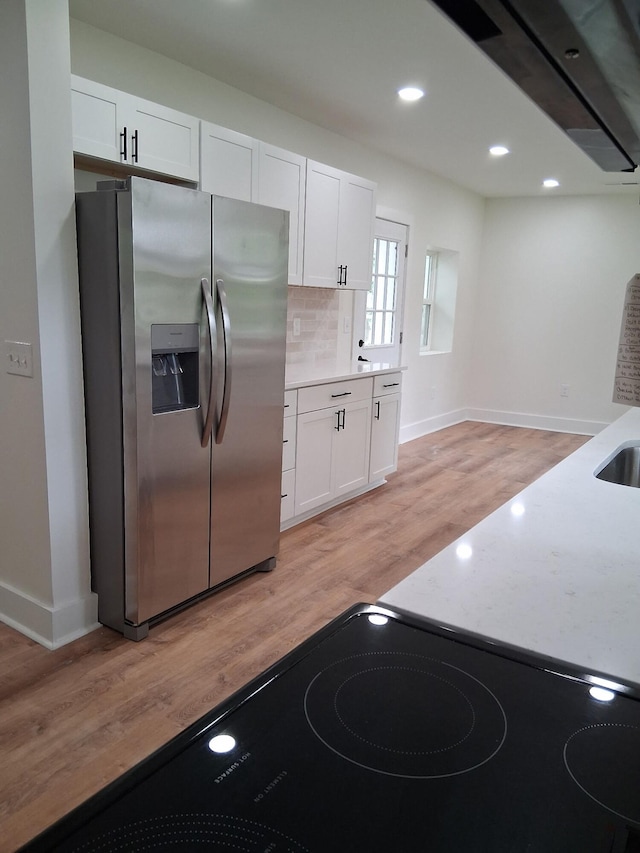 1302 Peter Pan Rd, Lookout Mountain, GA 30750 - kitchen with stainless steel fridge with ice dispenser, light wood-style flooring, baseboards, white cabinets, and recessed lighting