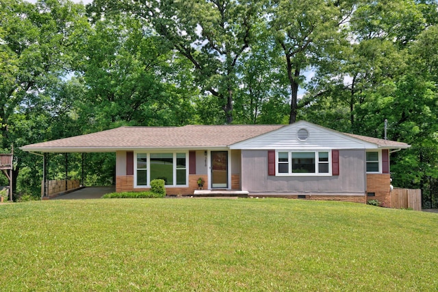 single story home with a carport, a shingled roof, a front yard, and crawl space